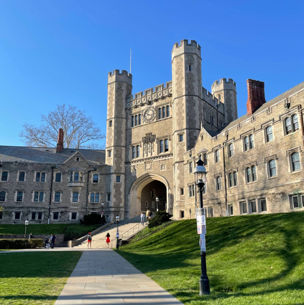 Photo of Princeton's Blair Arch with green grass in the foreground and a blue sky in the background.