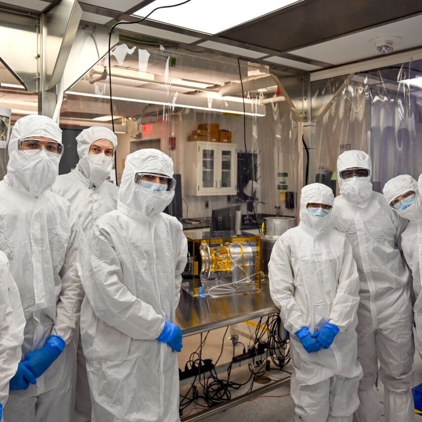 Rishika and her lab group at the Space Physics Laboratory with SWAPI, an instrument aboard the NASA mission IMAP.